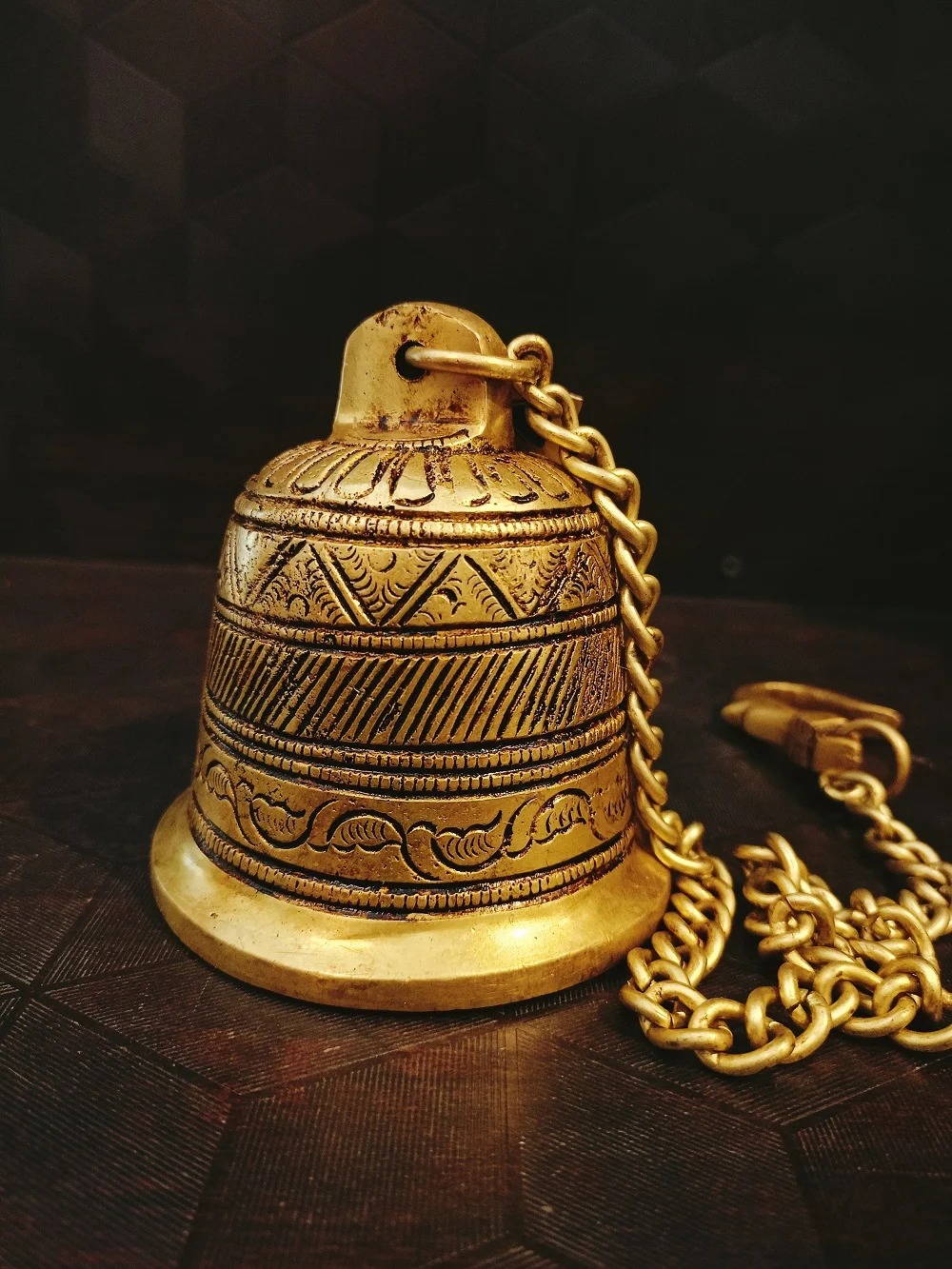 A brass wall hanging bell is a decorative item that can also be functional. They come in a variety of sizes, styles, and finishes, so you can find one that perfectly complements your home décor.A Bell hanging near your front door or pooja door can be used to announce visitors.l